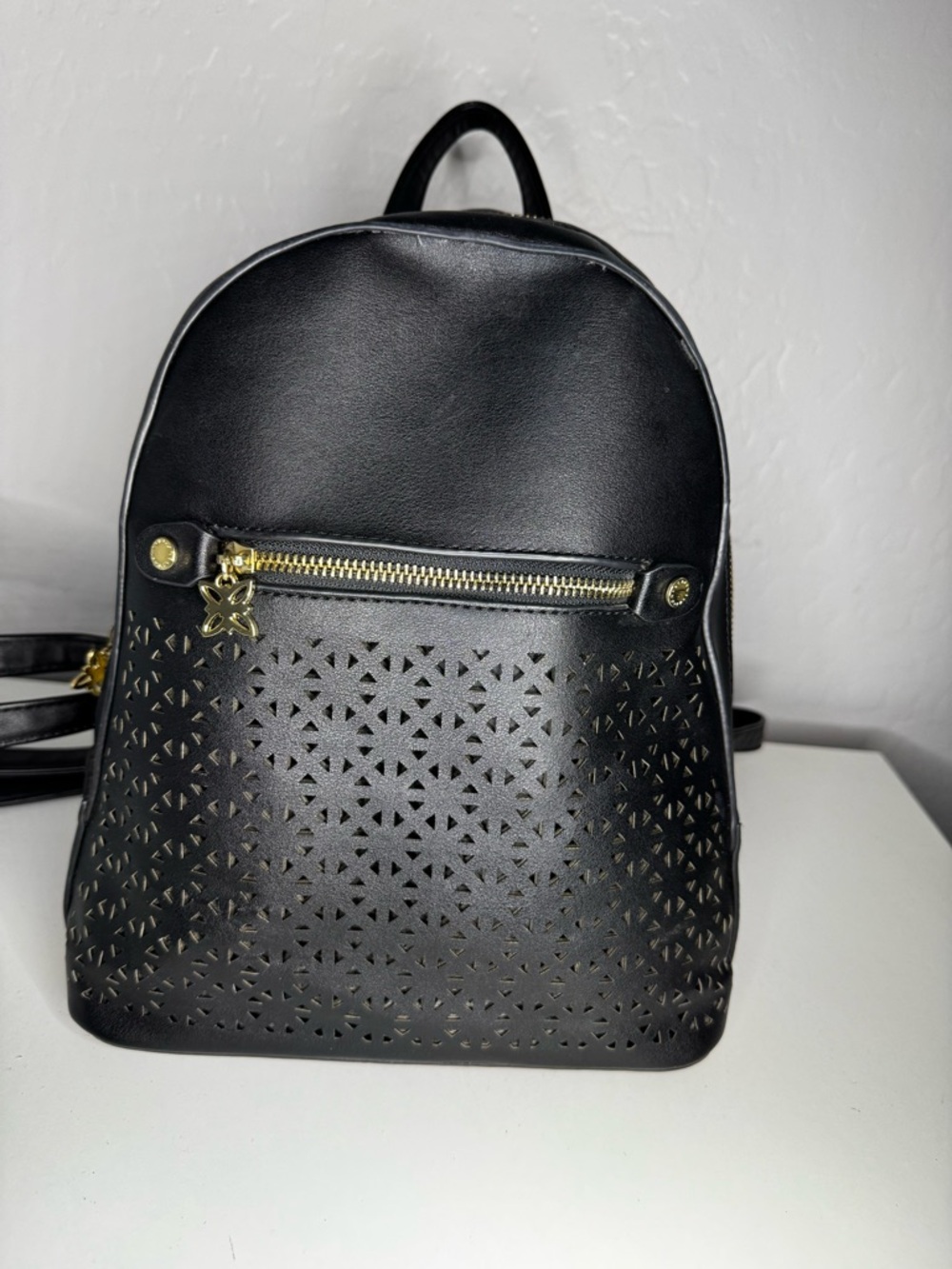 BCBG Black Women's Laser-Cut Mini Backpack with Gold Accents